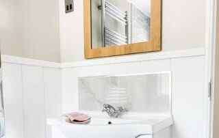 Plot 1 - Crowsheath Estate - Bathroom View - showing the sink and stainless radiator.