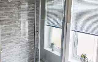 Plot 1 - Crowsheath Estate - Bathroom View - showing the shower and large window that fills the room with light.