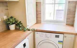 Plot 11 - The Cardigan Cottage utility Room with a washing machine and tumble drier - Crowsheath Estate park homes and lodges.